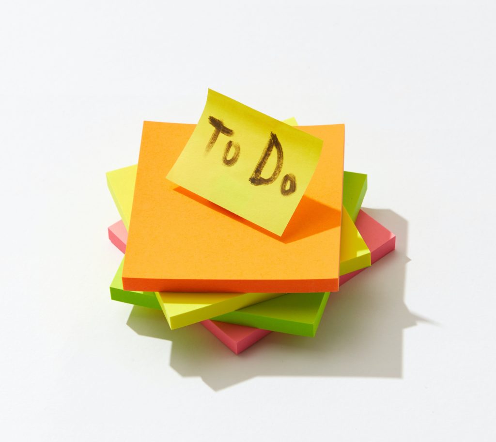 A stack of colored post-it notes, with ‘To Do’ written on the top one.