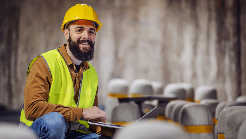 Man in a hard hat and fluorescent vest representing one type of secondary stakeholders.