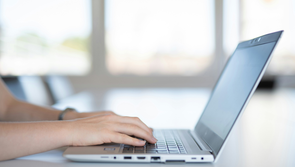 Person typing on a laptop.