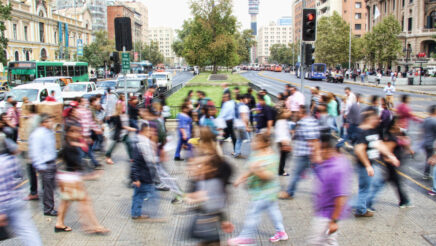 Community members walking across a road.