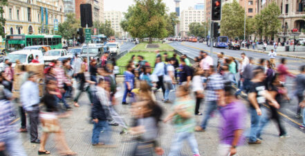 Community members walking across a road.