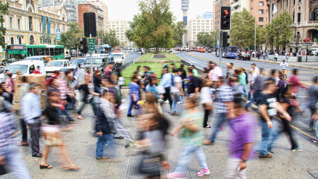 Community members walking across a road.