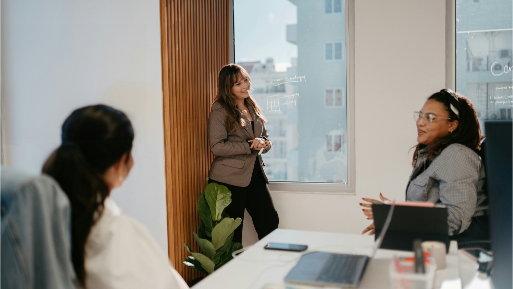 Women in a corporate environment holding a meeting.