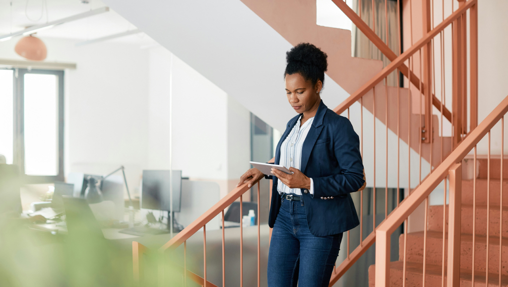 Corporate woman walking down stairs.