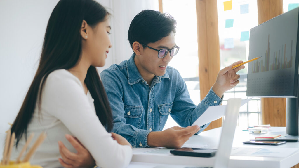Image of two people looking at a document