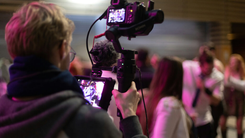 People being recorded to represent community storytelling.