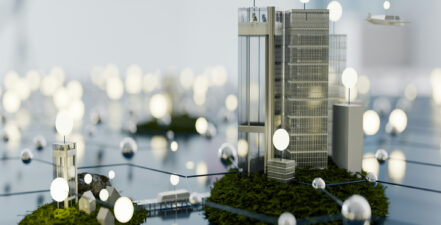 Models of corporate buildings surrounded by light bulbs to represent CSRD reporting and stakeholders.