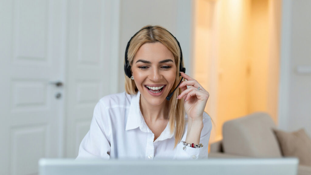 A woman using a headset, providing client support.