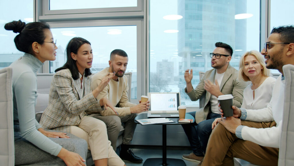 A team of people in an office having a heated discussion as they align stakeholder goals.