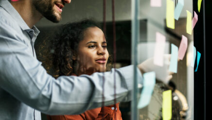 A man and woman using the agile project process. Image represents agile stakeholder engagement.