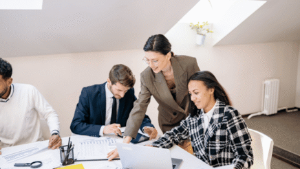 Image of people working together on reports