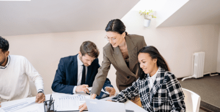 Image of people working together on reports